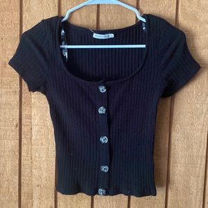 Low scoop neckline, black top